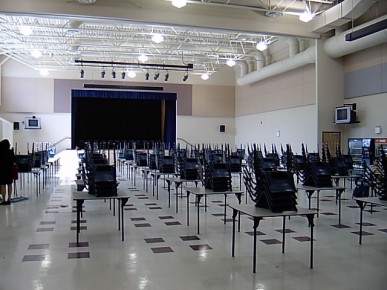 classroom with chairs on top of desks